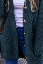 Dark green cable knit cardigan with wooden buttons and pockets