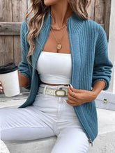Teal ribbed zip-up cardigan with balloon sleeves, pockets, and open front
