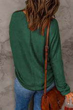 Teal round neck long sleeve top with button hem details