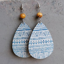Blue and white teardrop drop earrings with floral patterns and wooden beads