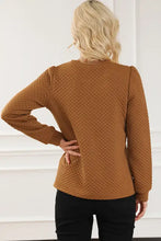 Texture round neck long sleeve sweatshirt with quilted brown fabric, puff shoulders, and elastic cuffs