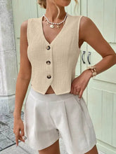 Beige textured sleeveless vest with a v-neckline and three dark buttons featuring a textured button-front design