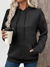 Black quilted floral pattern hoodie with textured design machine wash cold for easy care and comfort