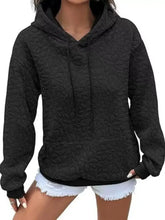 Black textured floral quilted hoodie with drawstring hood suitable for machine wash cold care instructions