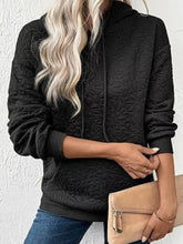 Black textured floral quilted hoodie made of soft fabric designed for casual wear and machine wash cold care