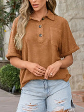 Rust-colored waffle-knit short-sleeved polo shirt with textured knit button details and a collar
