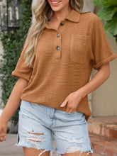 A cozy rust-colored textured knit button top with waffle knit fabric, classic collar, and three dark buttons