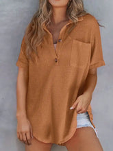 A loose-fitting mustard-yellow textured knit button short-sleeved top with a chest pocket and waffle knit texture