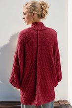 Red boucle cardigan sweater with high neck and long sleeves in teal, red, merlot