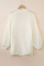 Cream-colored textured knit cardigan with bell sleeve length