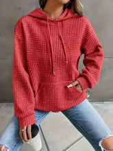 Red textured knit drawstring hoodie with front pockets made from slightly stretchy fabric machine wash cold