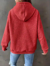 Red waffle-knit textured knit drawstring hoodie with a slightly stretchy fabric and cozy pattern, machine wash cold safe