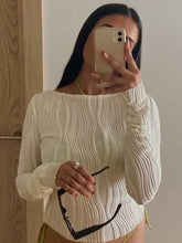 Off-white textured long sleeve fitted blouse in ribbed knit with boat neckline and ruched cuffs