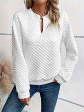 White quilted textured long sleeve notched sweatshirt with keyhole neckline made from slightly stretchy fabric machine wash care instructions
