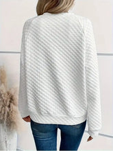 White quilted knit textured long sleeve notched sweatshirt with diamond pattern slightly stretchy and machine wash care instructions