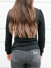 Woman in textured mock neck long sleeve t-shirt with brown hair