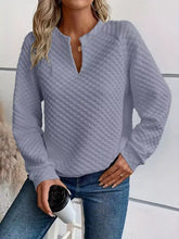 Light gray textured notched raglan sleeve sweatshirt with v-neck and subtle diamond pattern in slightly stretchy material