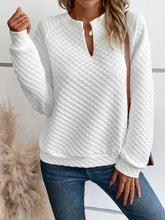 White quilted textured notched raglan sleeve sweatshirt with half-zip neckline ribbed cuffs and slightly stretchy material