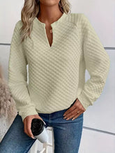 Cream-colored textured notched raglan sleeve sweatshirt with v-neck button detail in slightly stretchy material