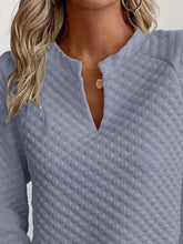 Light blue textured notched raglan sleeve sweatshirt with a subtle diamond pattern and slightly stretchy material