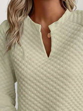A soft mint green textured notched raglan sleeve sweatshirt with a subtle diamond quilted pattern and slightly stretchy material