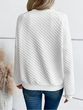 White textured notched raglan sleeve sweatshirt with quilted knit fabric ribbed hem and cuffs machine wash cold