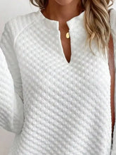 White quilted long-sleeve textured notched raglan sleeve sweatshirt with subtle diamond pattern and keyhole neckline in slightly stretchy material