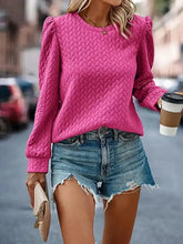 Vibrant pink textured round neck long sleeve blouse in slightly stretchy knit with quilted puffed sleeves