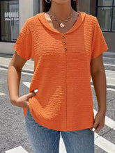 Orange textured short sleeve blouse with button front and cowl neckline suitable for casual wear