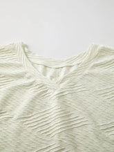 Cream textured V-neck top with dropped shoulder and wide short sleeves