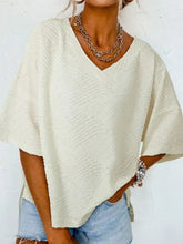Off-white textured V-neck top with dropped shoulder and wide short sleeves