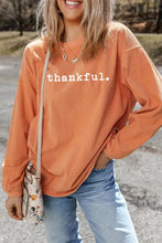 Orange thankful round neck long sleeve sweatshirt with thankful text