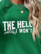 Green long sleeve sweatshirt with THE HELL I WON’T text and floral graphic