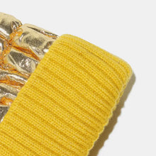 Yellow ribbed knit cuff on metallic gold puffy glove for thermal knit hat