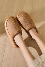Pair of brown suede thermal round toe platform slippers with visible stitching