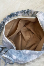 Gray and white tie-dye canvas sling bag with zipper and ruched strap