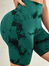 Green tie-dye active shorts with black bat print, ribbed texture, crotch seam