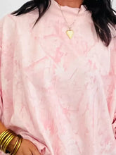 A soft pink tie-dye oversized mock neck sweatshirt with slightly stretchy fabric and loose flowing sleeves machine wash cold