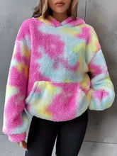 A cozy tie-dye plush fleece hoodie in vibrant pink yellow and light blue hues machine wash cold recommended
