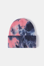 Tie-dye woolen beanie hat in yellow, orange, pink, and blue hues with ribbed texture
