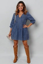 Tie neck long sleeve mini denim dress with v-neck, three-quarter sleeves, and slightly stretchy drawstring waist