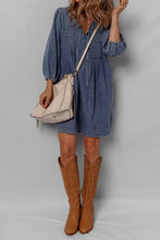 Beige crossbody bag with stitched detailing and zipper closure paired with a slightly stretchy mini denim dress