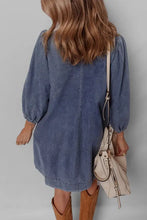 Blue denim mini dress with puffed sleeves, tie neck, and relaxed slightly stretchy fit in long sleeve design