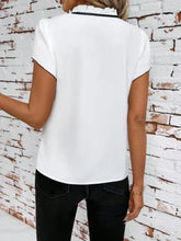 White tie neck short sleeve blouse with black ruffled collar trim in lightweight fabric for elegant wear