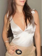 Silver satin tie shoulder cami with deep v-neckline and delicate bow detail on the shoulder