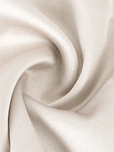 Cream-colored tie shoulder satin cami fabric with a smooth glossy finish and gentle folds in white satin tone