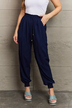 Women’s navy blue tied long joggers with high-waisted drawstring and pockets