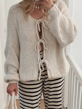 Cream fluffy tied long sleeve dropped shoulder knit cardigan with lace-up front and striped pants