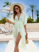 Woman in tied plunge half sleeve cover up with woven handbag