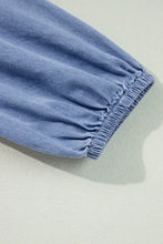 Light blue denim dress with tied plunge neckline and three-quarter sleeves featuring gathered elasticated cuffs care instructions